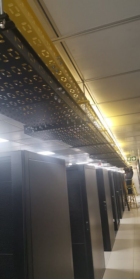 Data centre hall with overhead cable containment above server racks