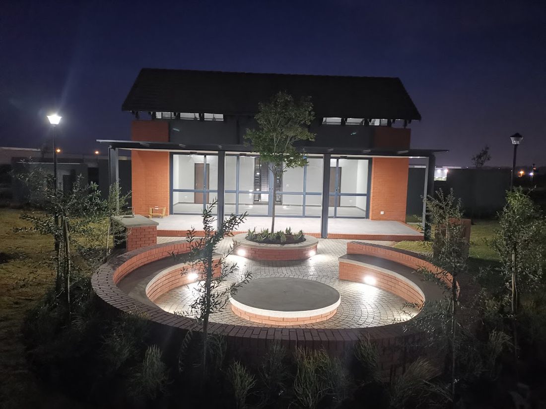 Completed commercial building with exterior lighting at dusk