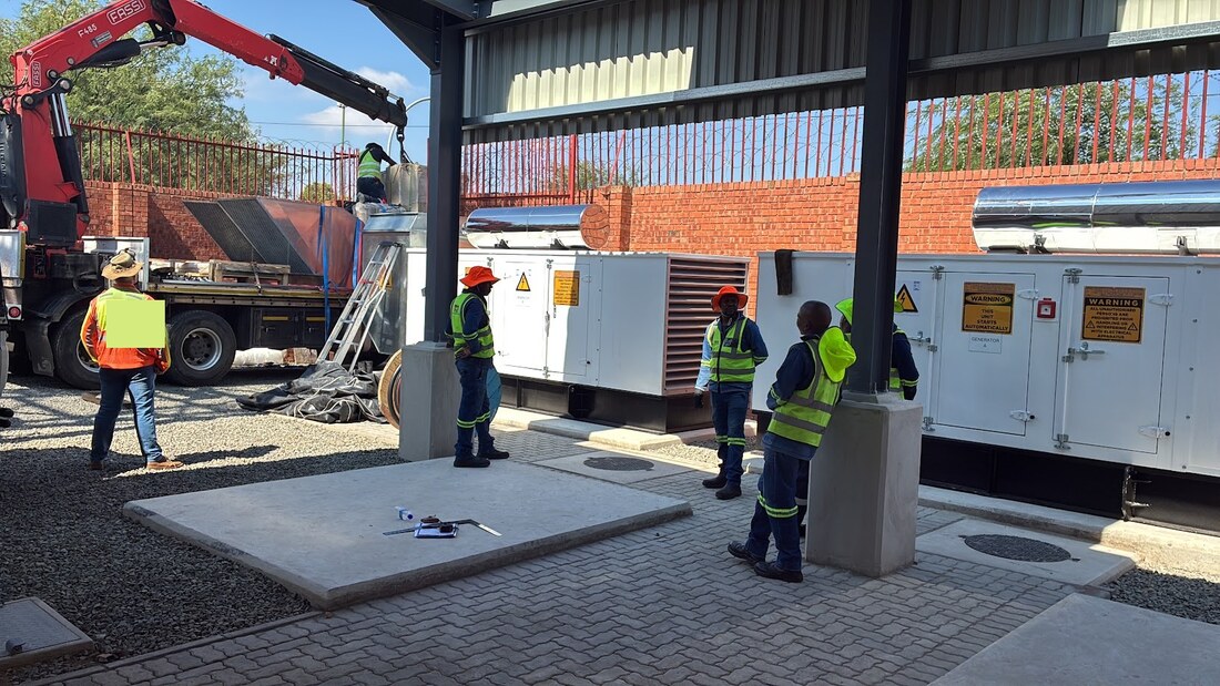 Crane offloading electrical plant on site